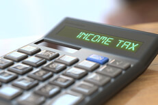 Calculator reading Income Tax Tax concept image of a calculator with LCD reading Income Tax