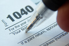 1040 tax form signature Close up photo of ballpoint pen signature on 1040 tax form