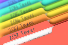Tax year folders Photo of prior tax year rainbow-colored manila folder tabs in filing cabinet
