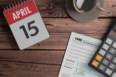 Time to file taxes Daily calendar showing April 15 with coffee, calculator, and IRS form 1040