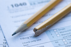 Tax frustration broken pencil Broken, splintered pencil on IRS 1040 tax form showing tax filing frustration or confusion