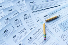 Broken pencil with tax forms Broken pencil lying on many IRS tax forms concept for tax filing frustration or confusion