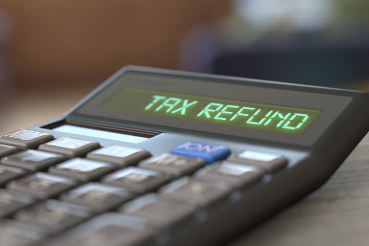 Calculator with LCD reading Tax Refund with nice interior bokeh background
