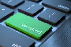 Tax refund keyboard key Dark laptop keyboard with green tax refund key