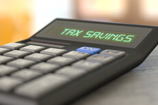 Tax saving calculator Perspective photo of calculator showing Tax Savings on LCD display