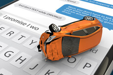Texting while driving rollover concept Car with extensive damage on top of cell phone showing text messages