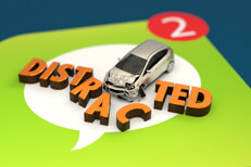 Small car with damage crashed through DISTRACTED letters on top of mobile messaging app icon alt
